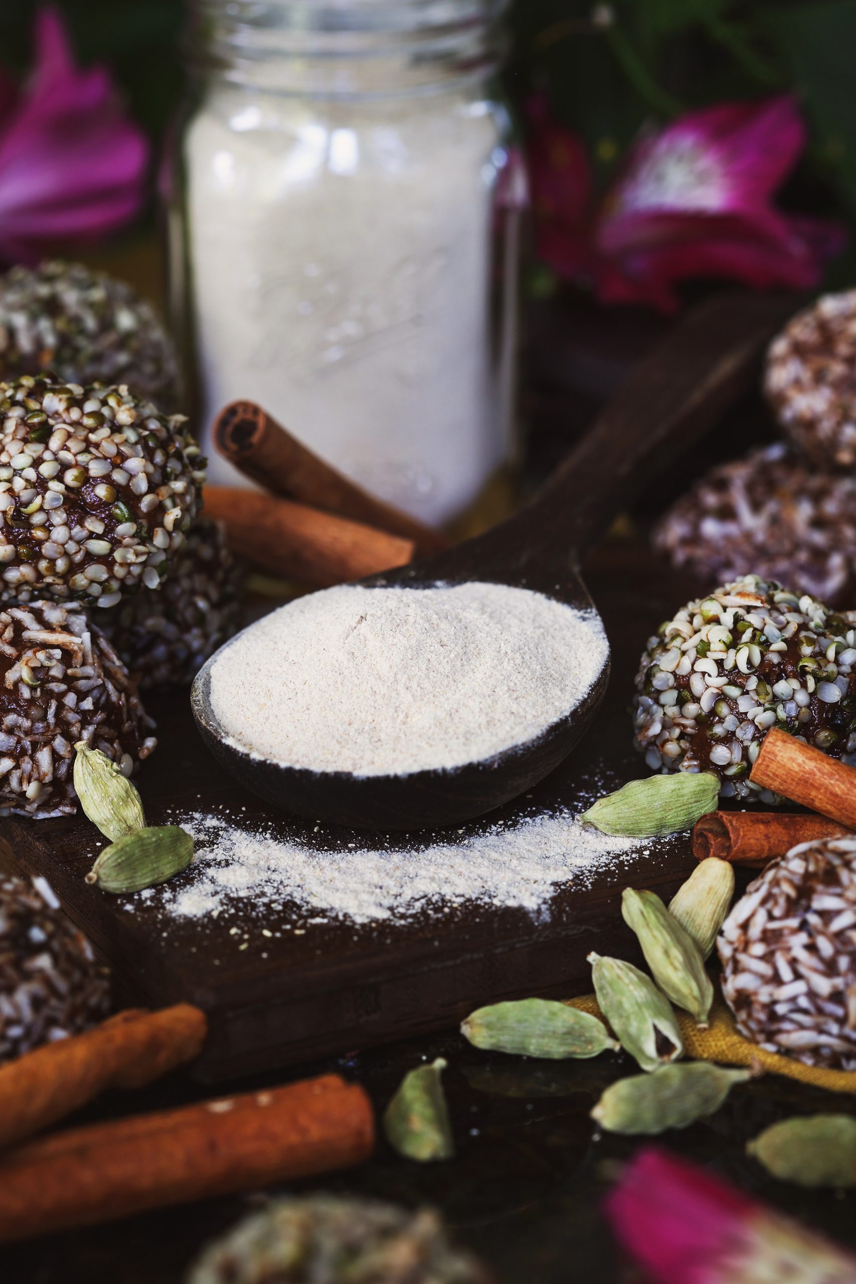 A spoonful of ashwagandha powder sits amidst paleo bites