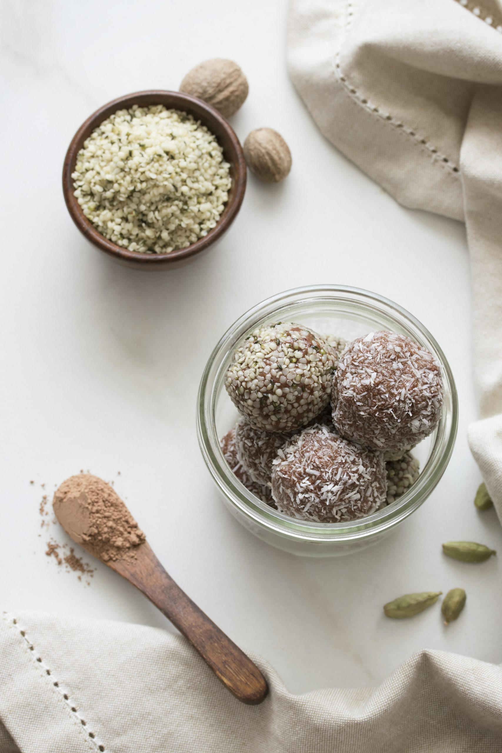 Glass filled with chocolate balls with garnishments surrounded by ingredients used to make them. 
