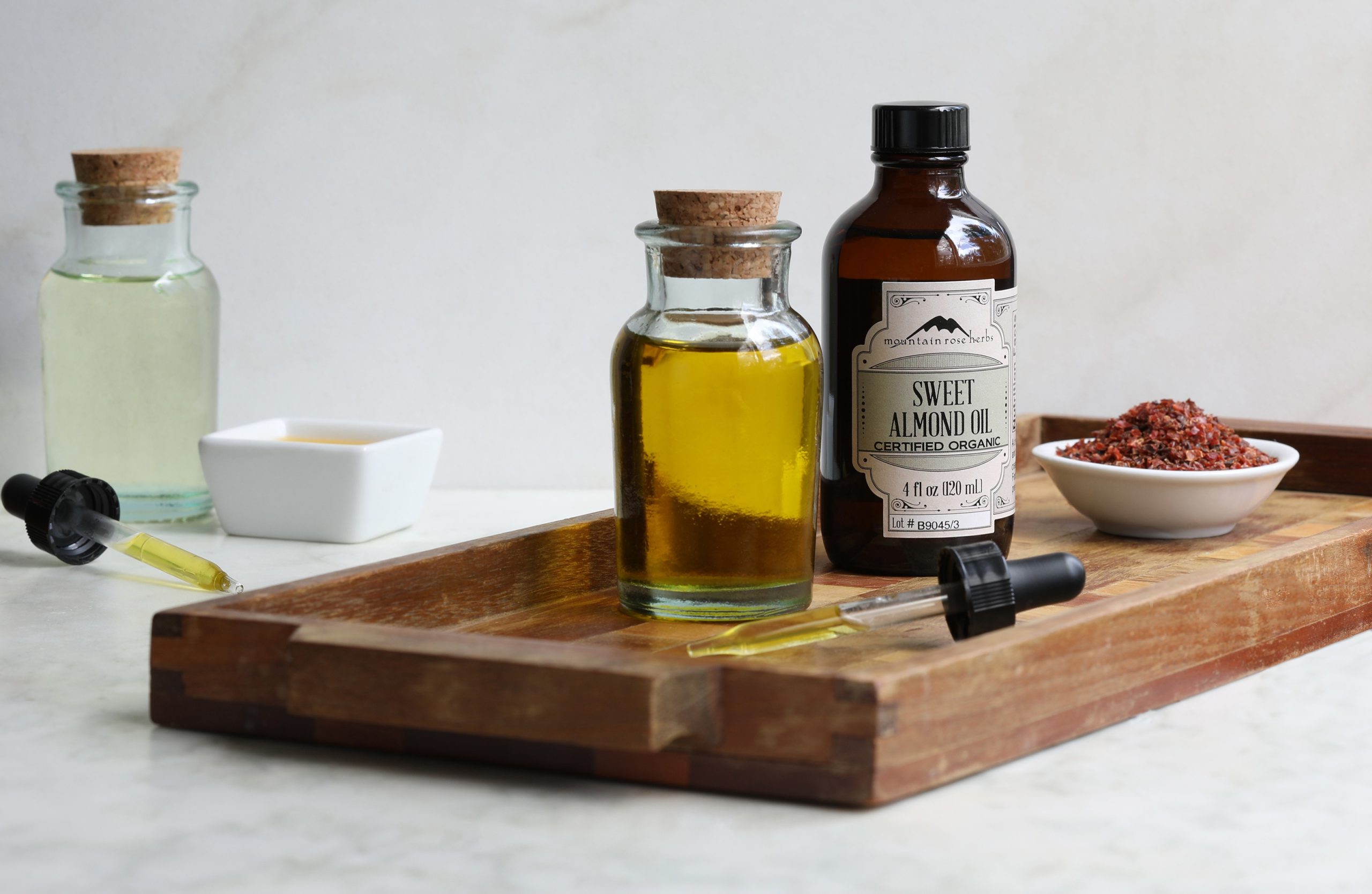4 oz. bottle of sweet almond oil with glass bottle of oil on stray