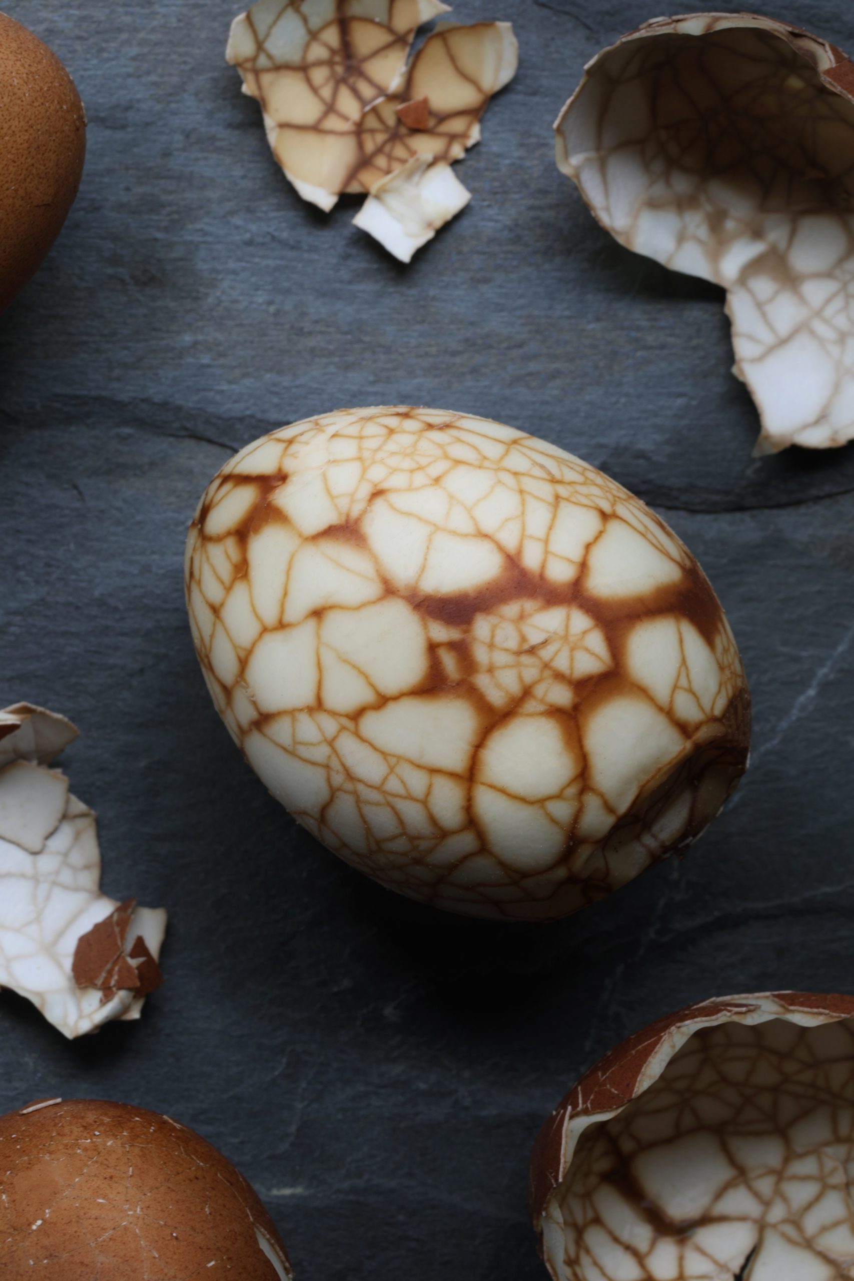 Close up photo of marbled tea egg showing brown lines along cracked area Close up photo of marbled tea egg showing brown lines along cracked area