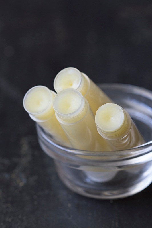 Clear tubes of lip balm in glass bowl