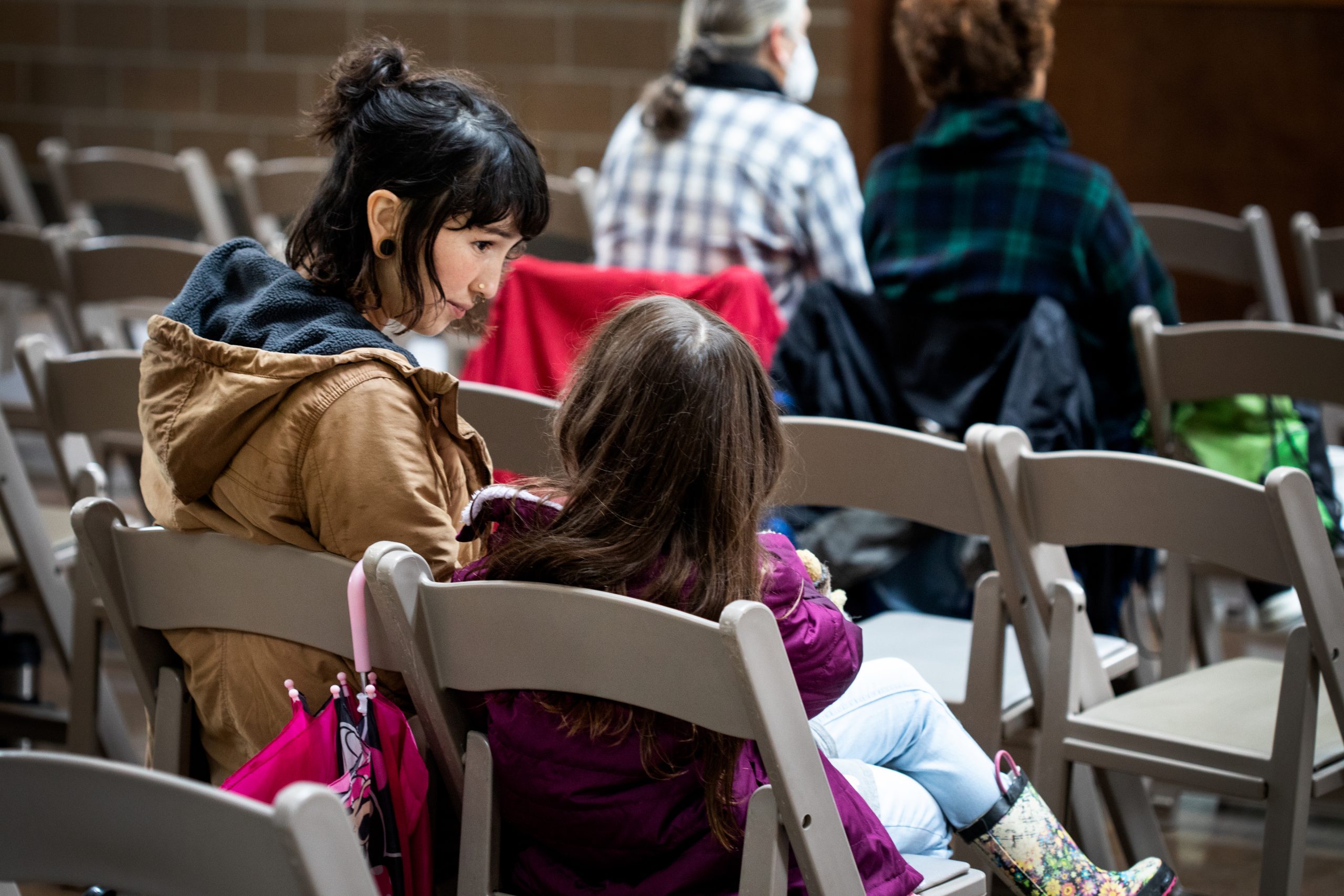 A mother interacts with her daughter in between presentations at an herbal conference.