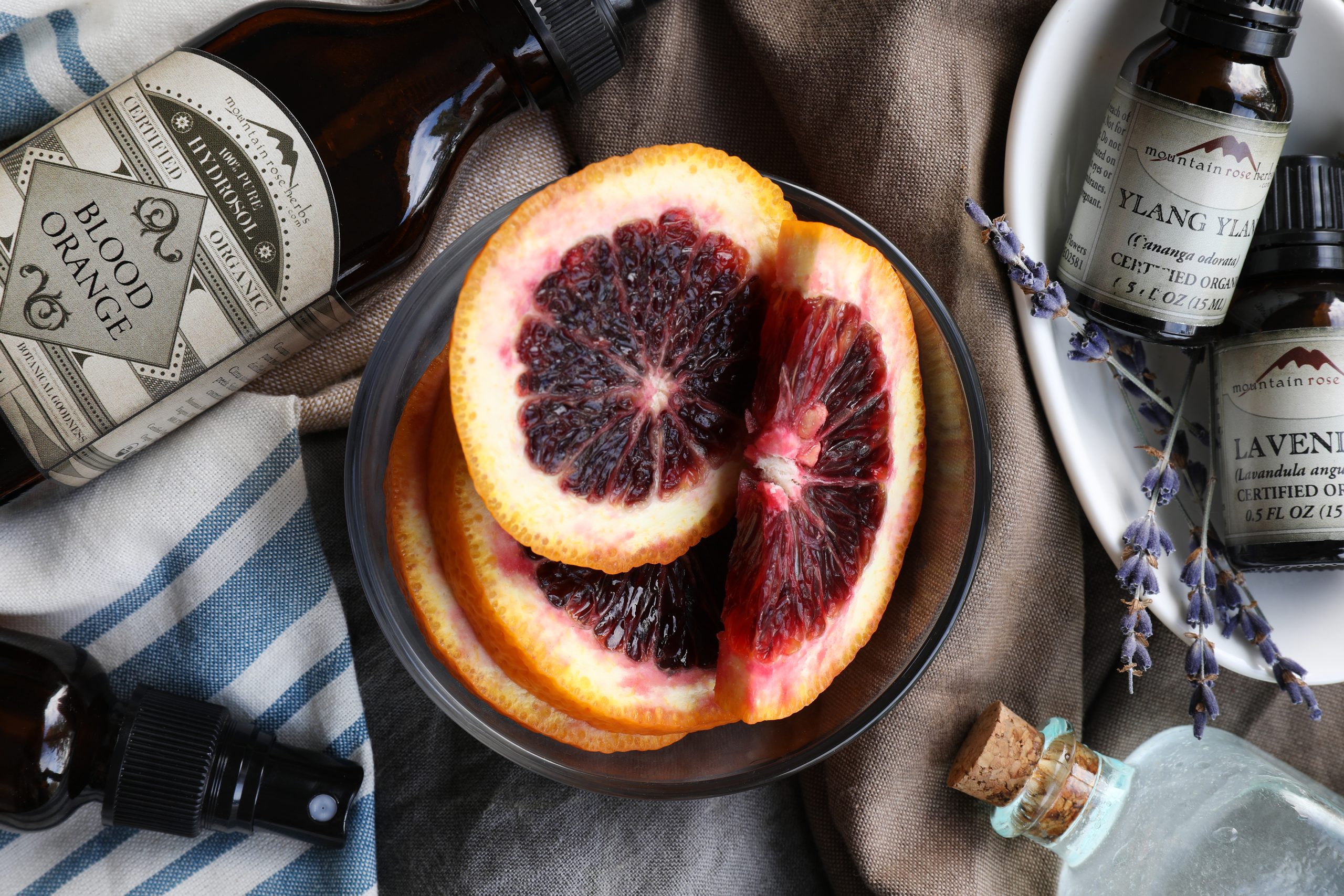 Homemade citrus room and fabric freshener spray ingredients including blood oranges, blood orange hydrosol, essential oils, and lavender.