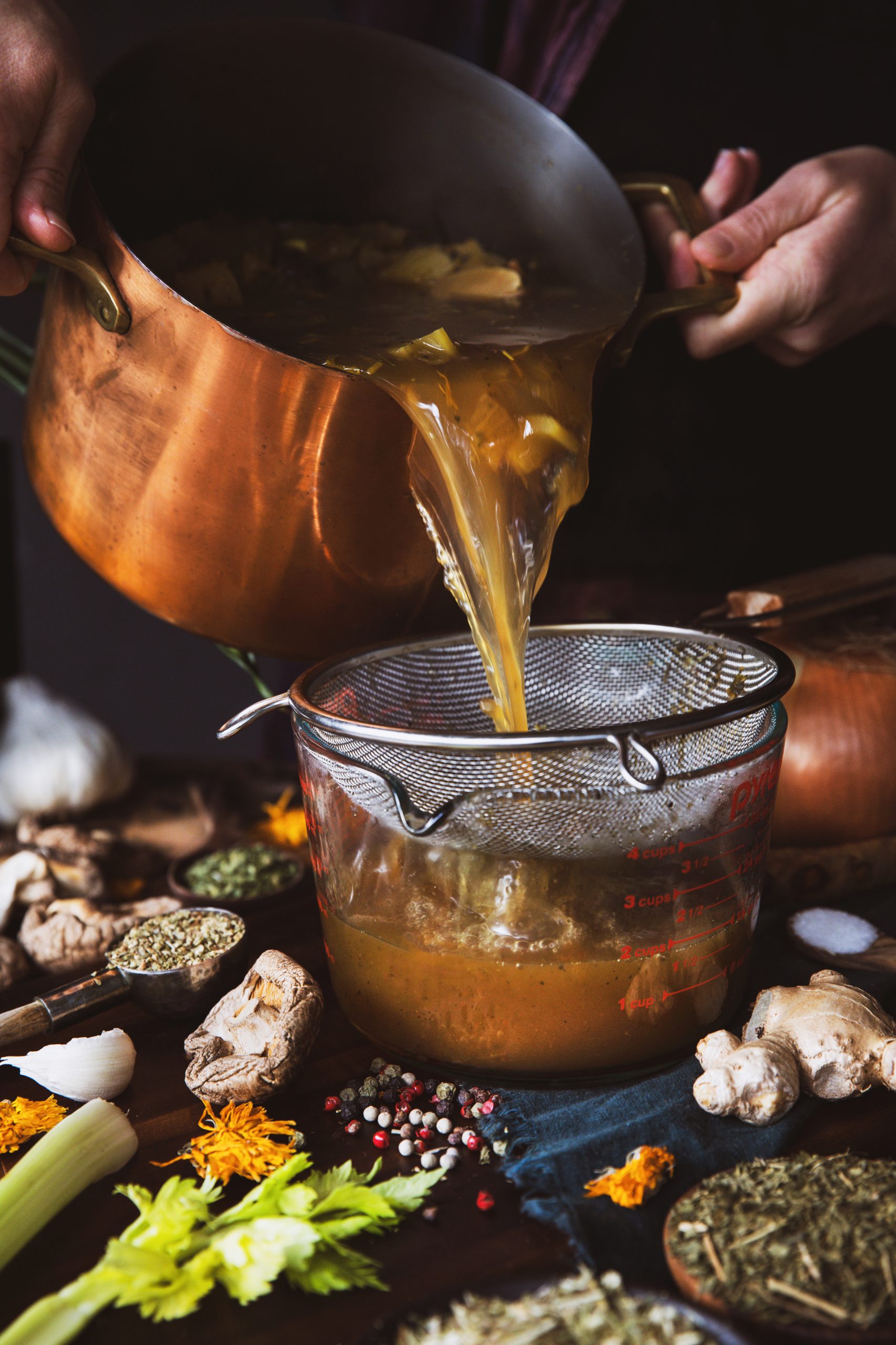 Freshly made herbal broth being strained 