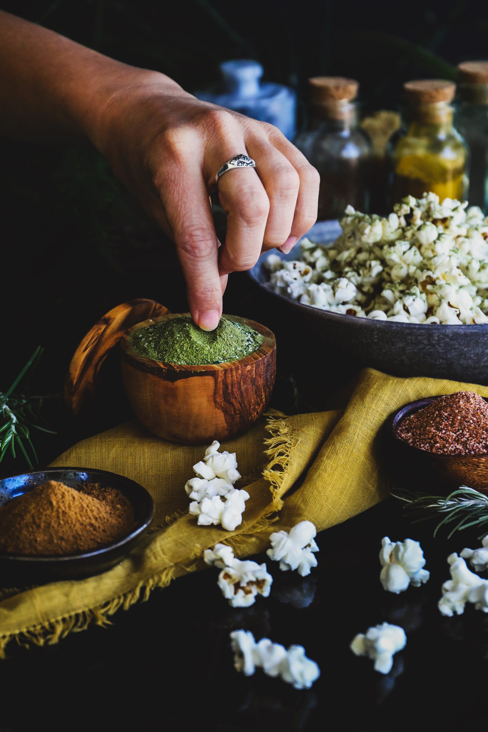 Adding a pinch of herbal salt to popcorn