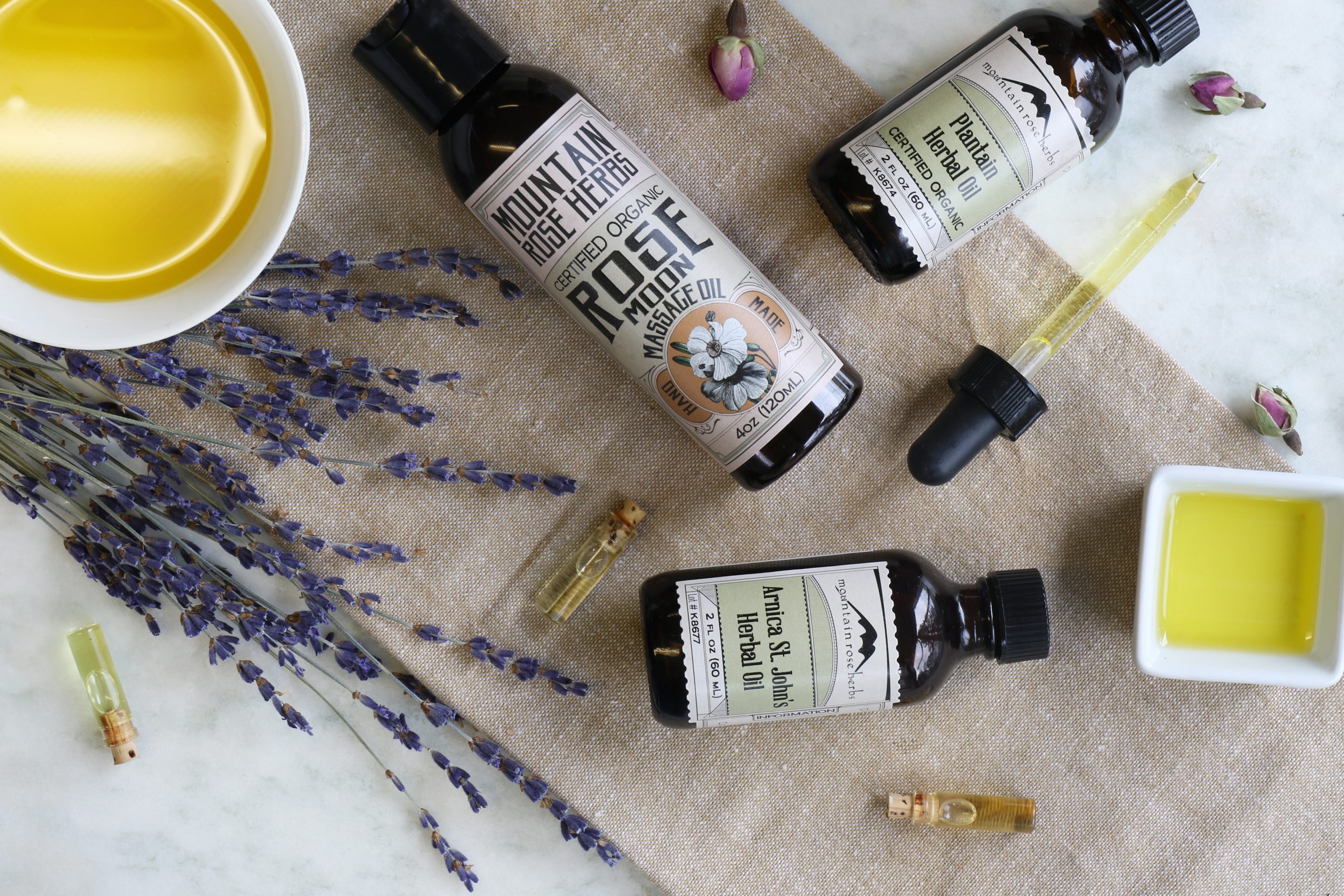 Natural rose moon massage oil arranged with some organic ingredients like fresh lavender, essential oils, and herbal infused oils of plantain and Arnica.