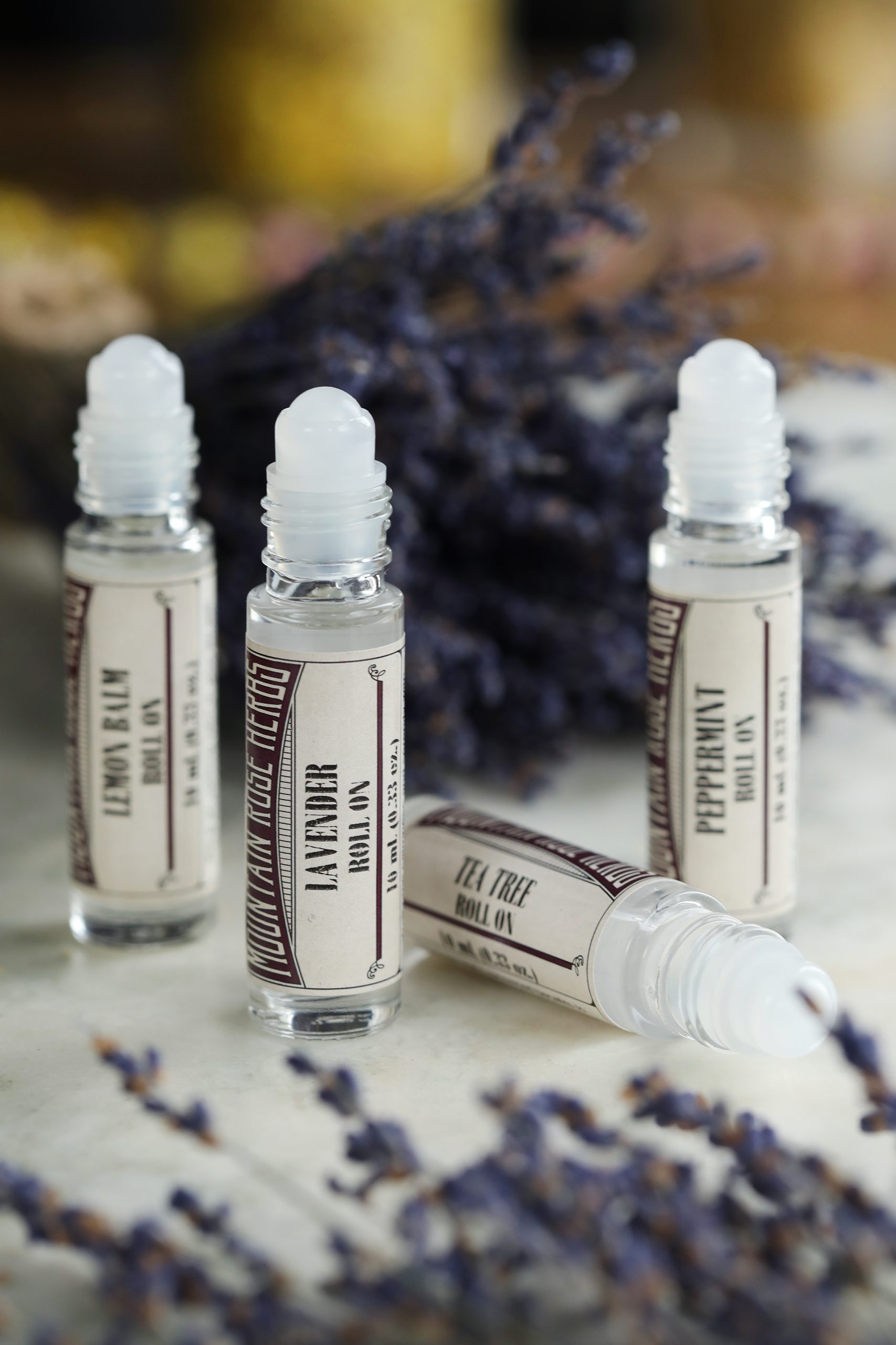 Essential oil roll-ons for everyday use include lavender, peppermint, tea tree, and lemon balm oils in convenient roller top bottles for portability. 