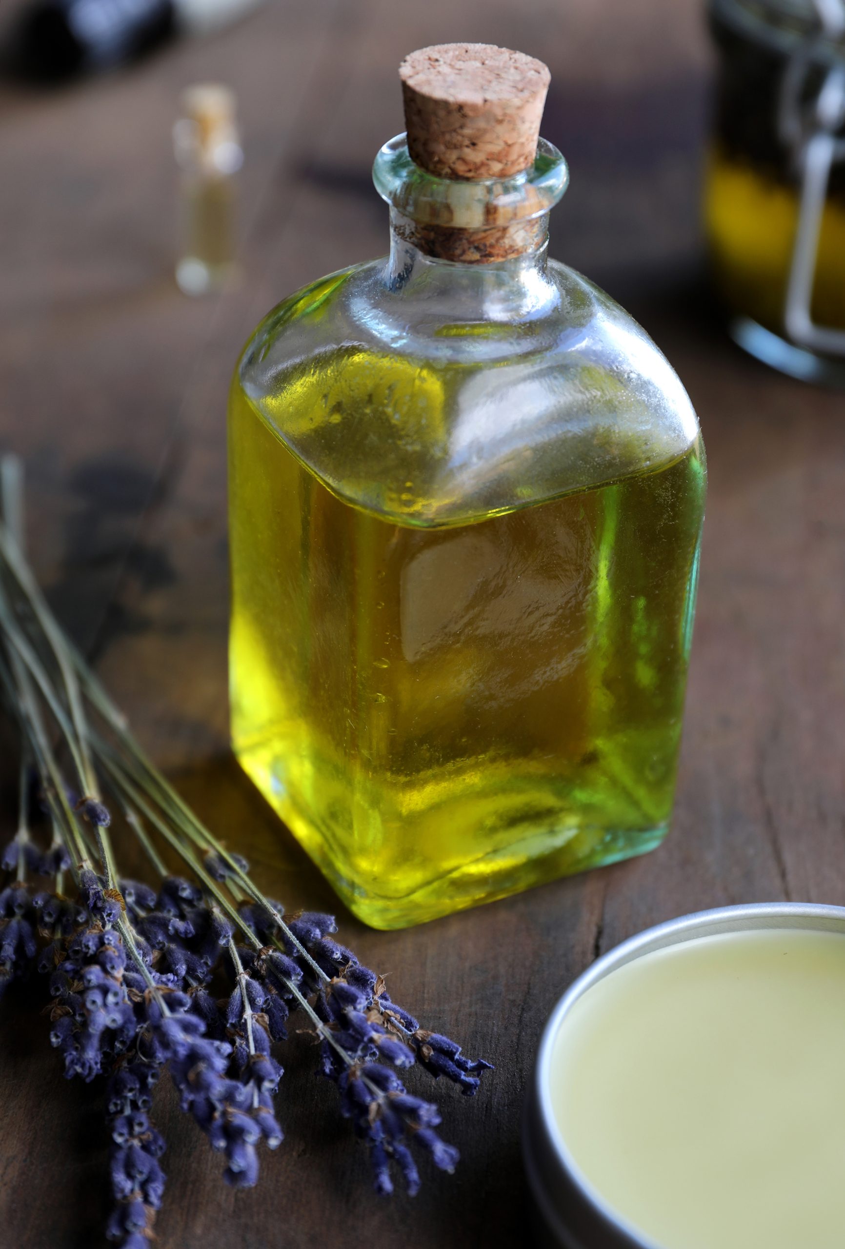 Golden organic jojoba oil in a vintage glass container. Jojoba oil can be blended with other botanical ingredients like lavender to make natural skin salves.