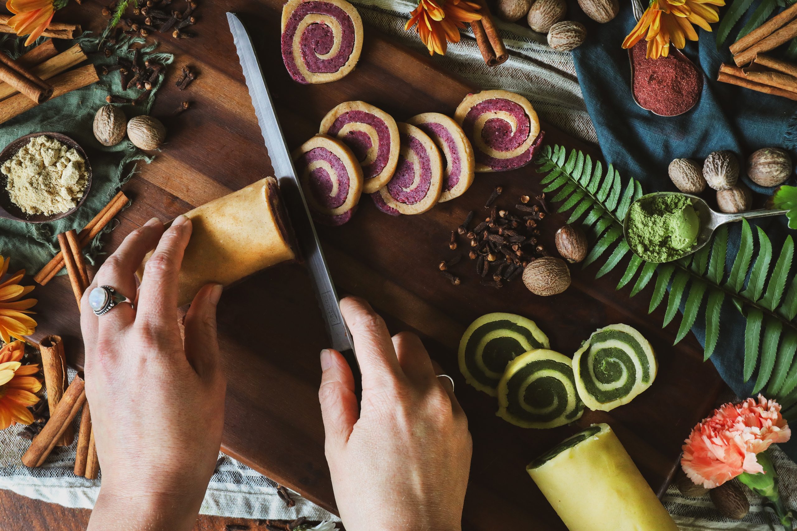 Pinwheel cookie dough is cut into discs