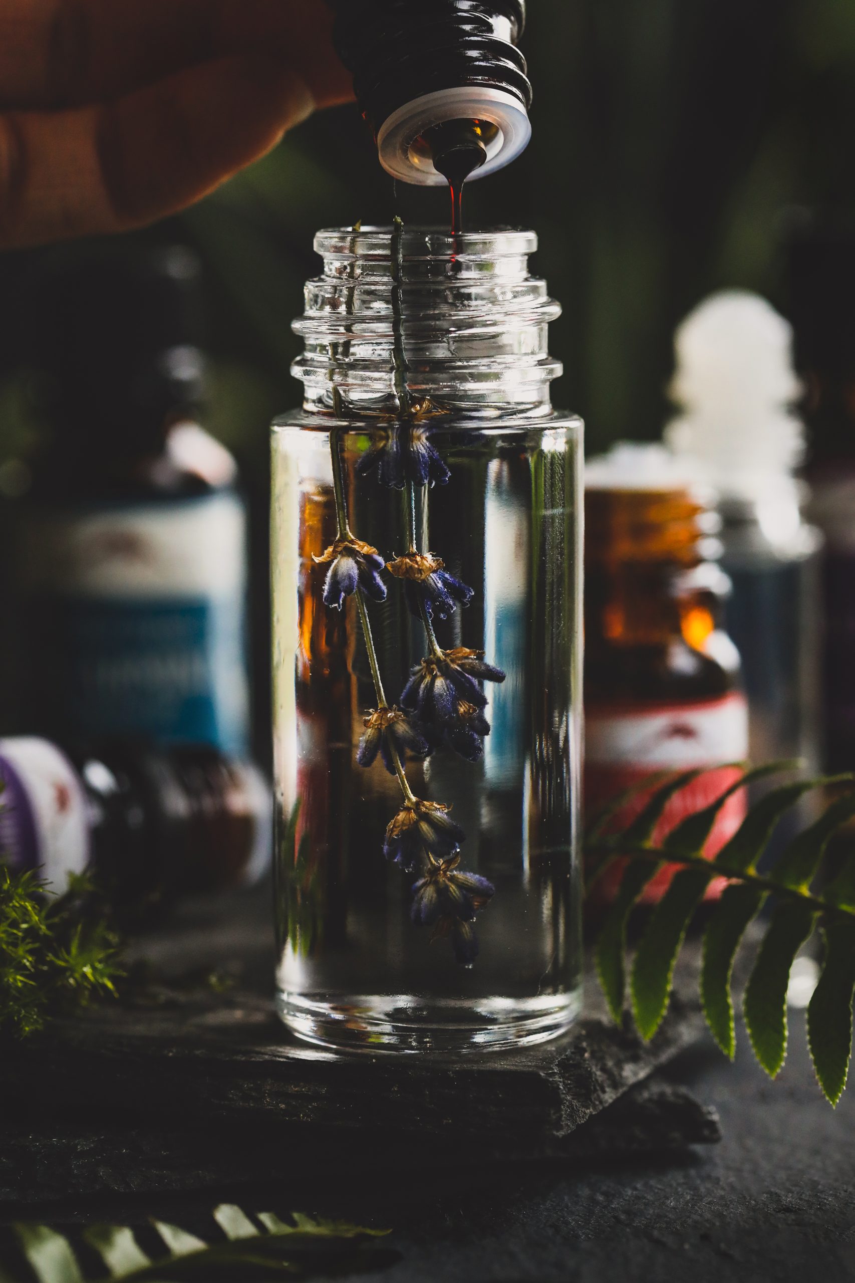 Benzoin Resin Oil being dropped into a glass bottle of carrier oil.