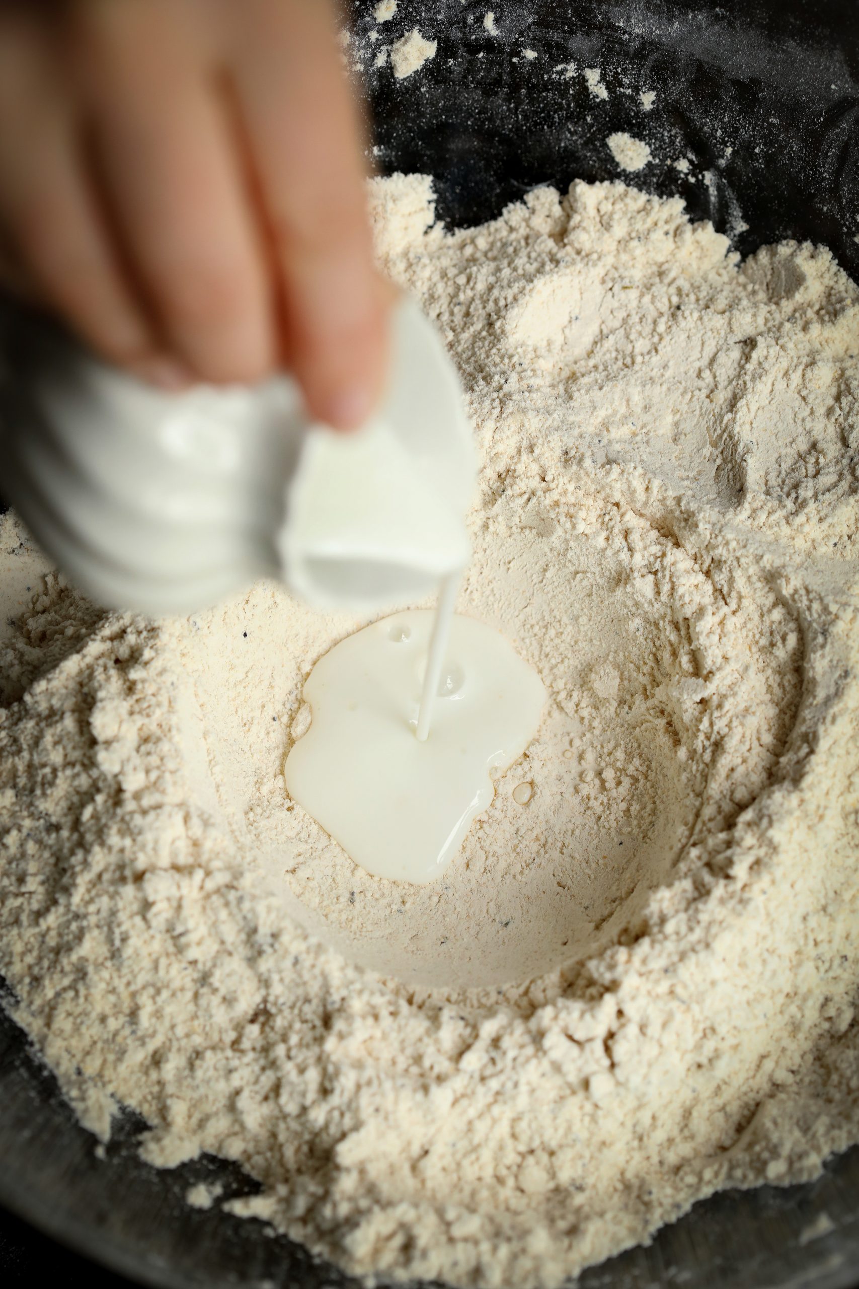 Adding buttermilk to the dry ingredients for making an Irish soda bread with nutritious seeds. 