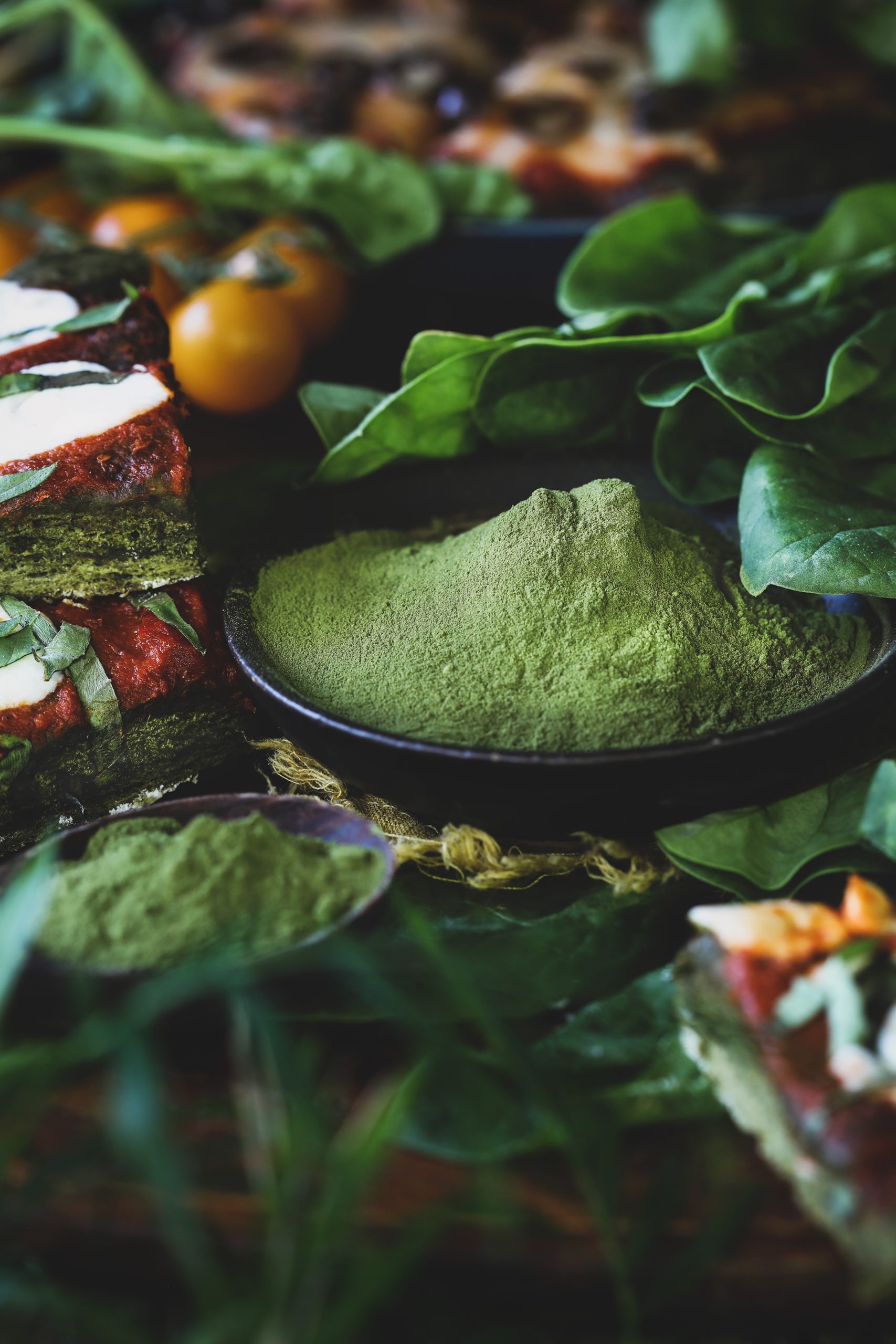 A dish with vibrant spinach powder sits out waiting to be used