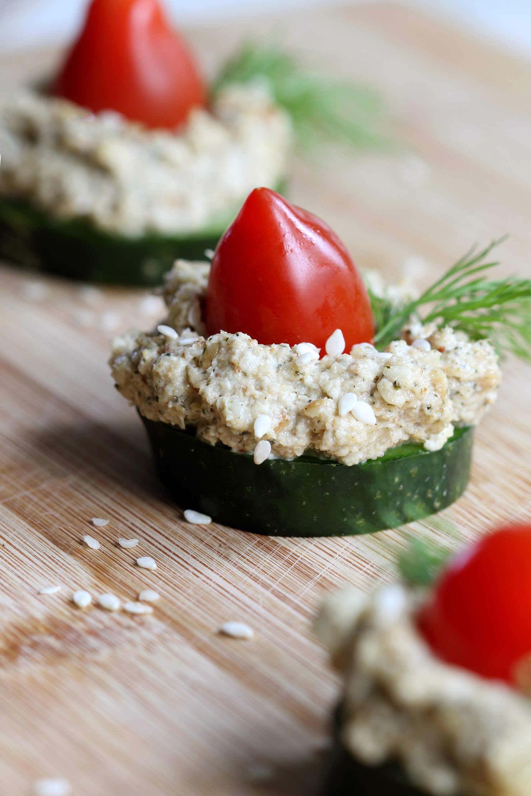Organic tahini appetizers made with fresh cucumber, tomatoes, dill, and homemade organic tahini spread using hemp seeds and sesame seeds.