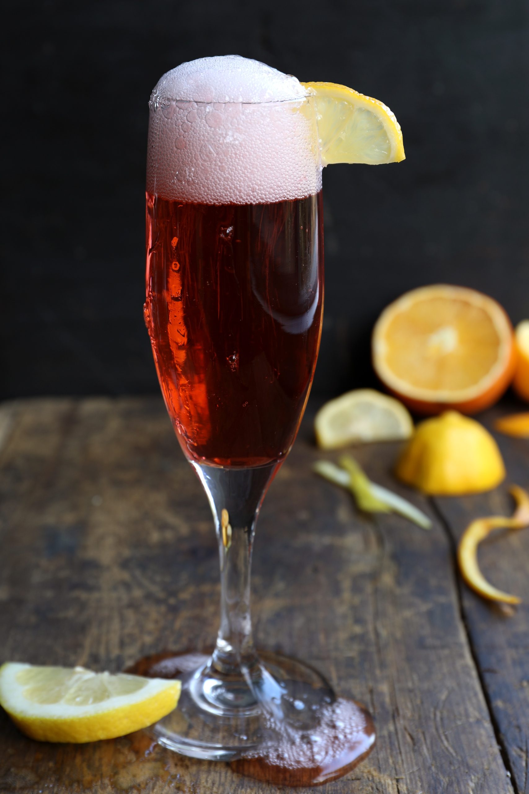 Red champagne drink with bubbly top, made with campari, vermouth, and organic gin Red champagne drink with bubbly top, made with campari, vermouth, and organic gin