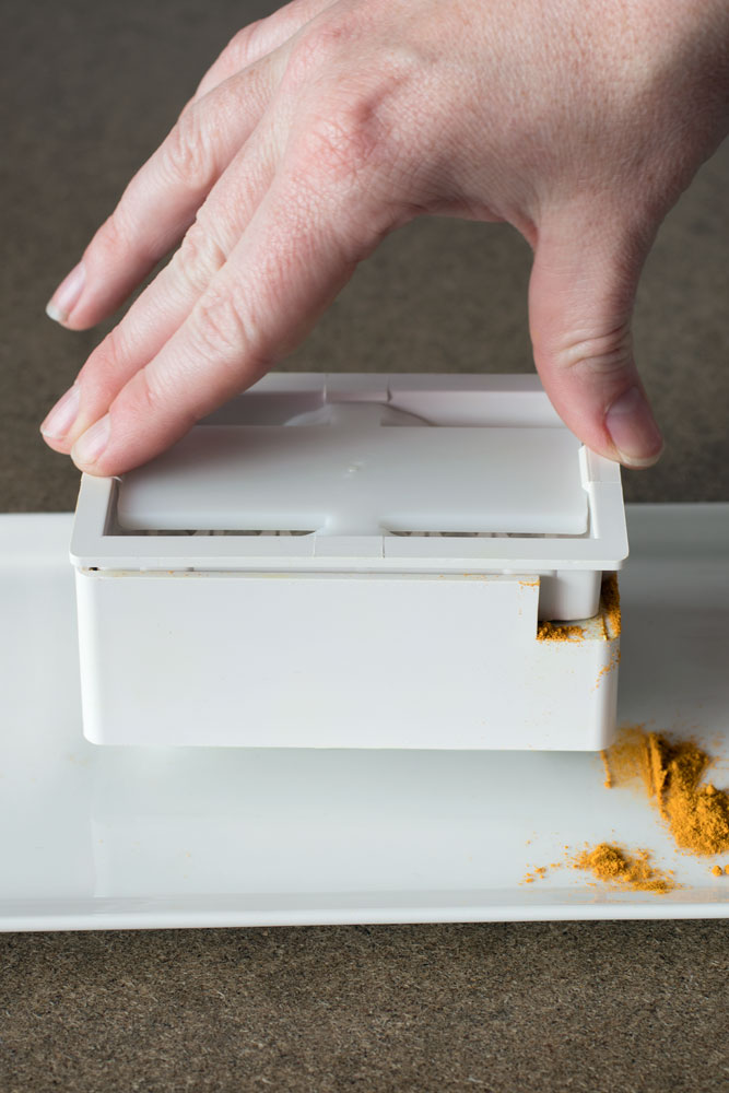 Tamping down on the capsule machine sometimes causes powder to spill over the edge