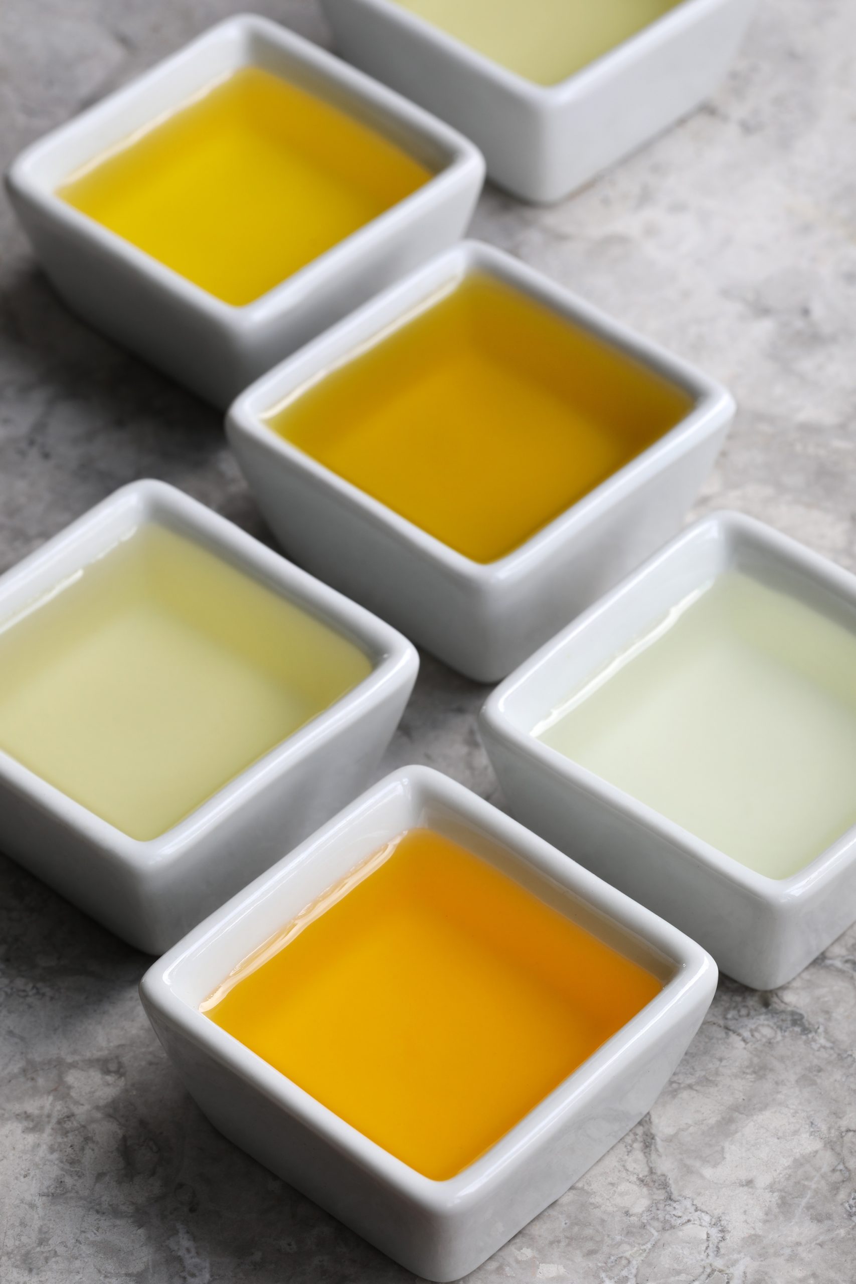 White porcelain bowls with carrier oils in them 
