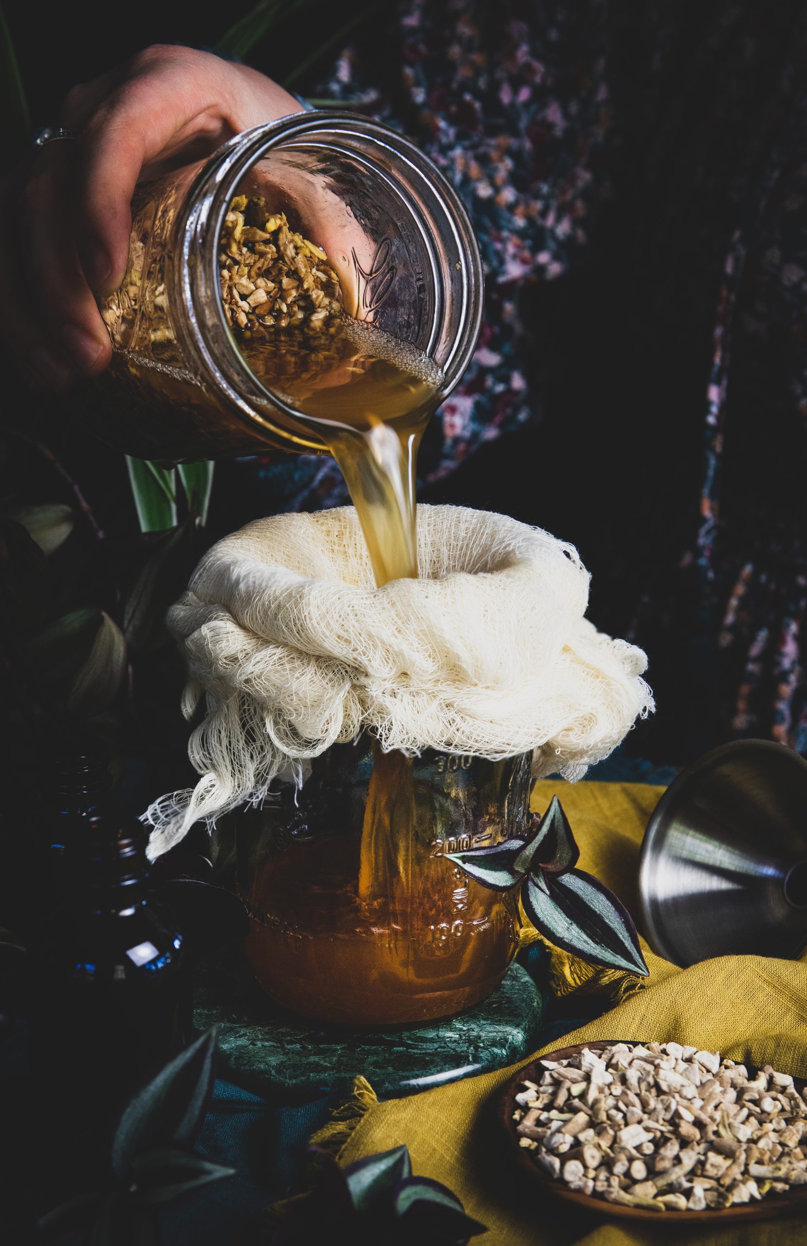 Someone strains a fresh made ashwagandha extraction