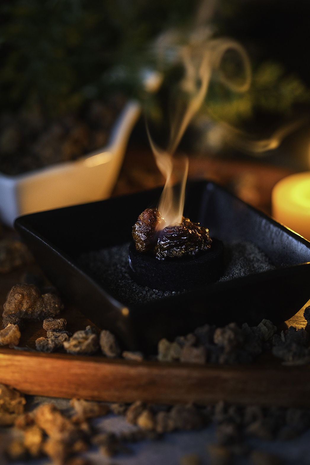 Myrrh resin on a charcoal round with smoke curling up