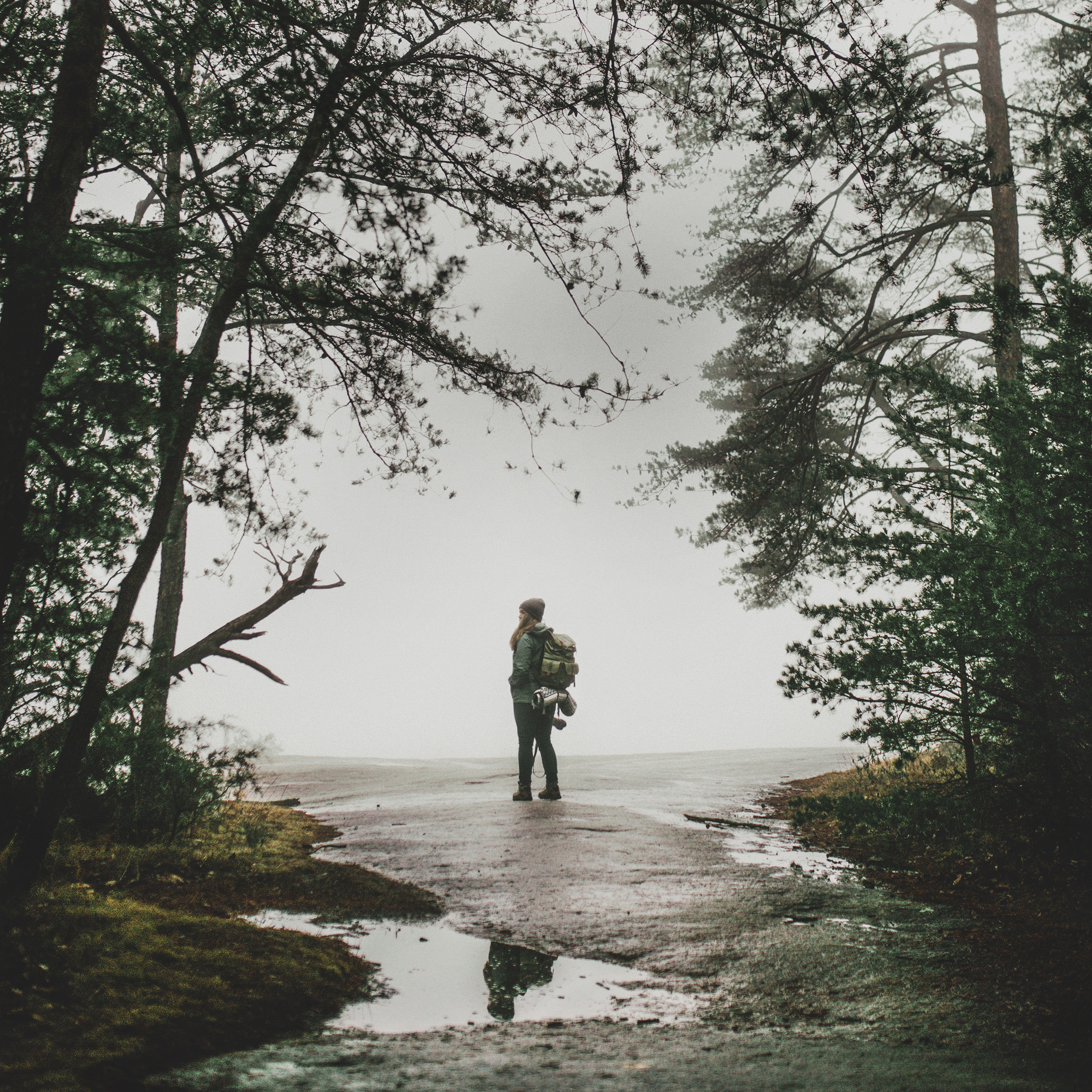 A hiker on the beach with a backpack