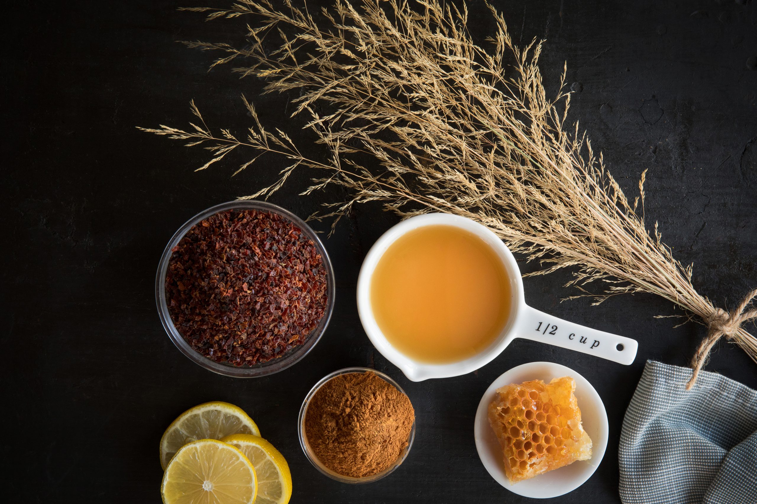 Ingredients to make a classic rosehip jam include dried rosehips, apple juice, cinnamon powder, raw honey, and lemons.
