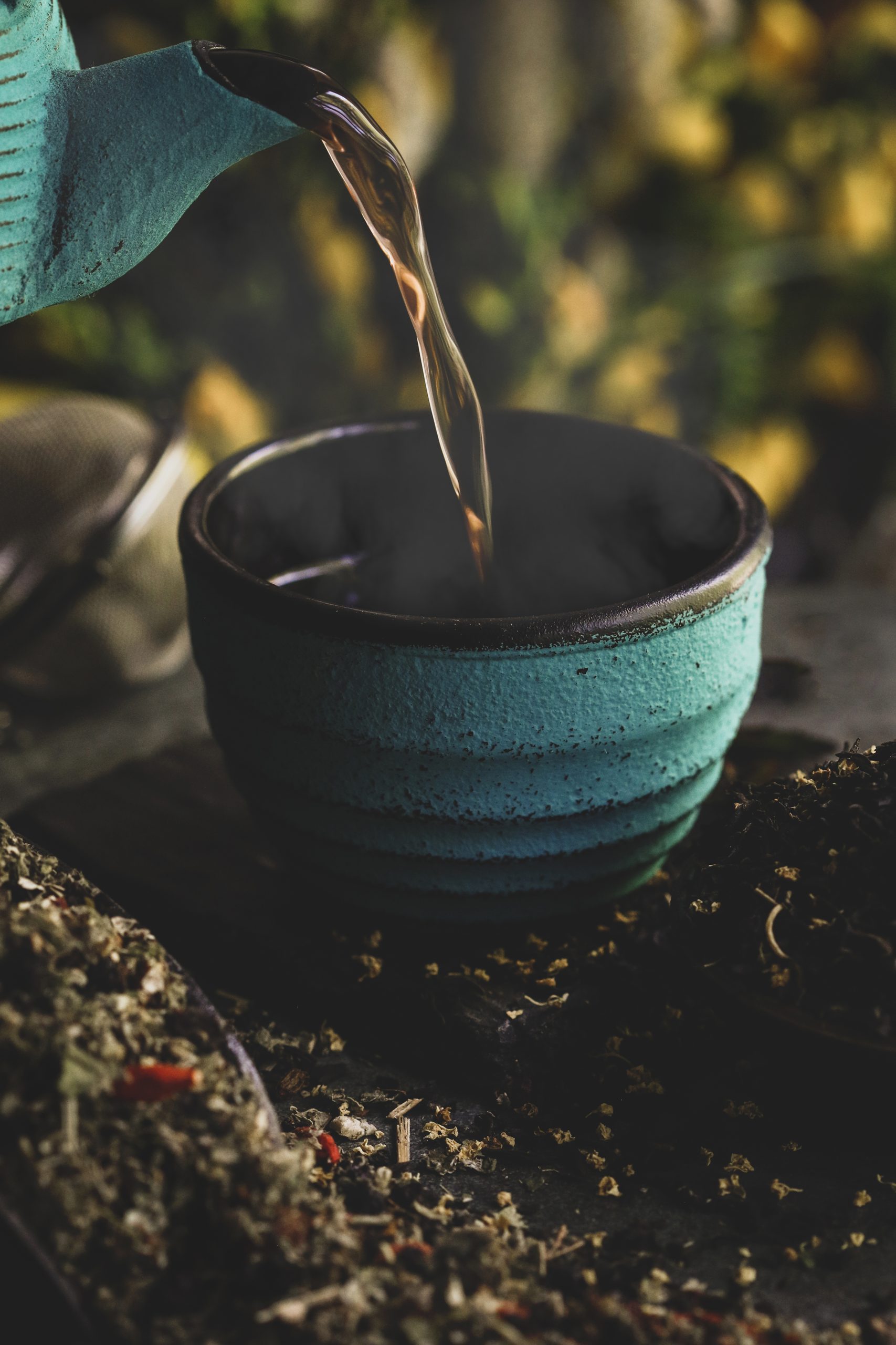 A tea pot pouring tea.