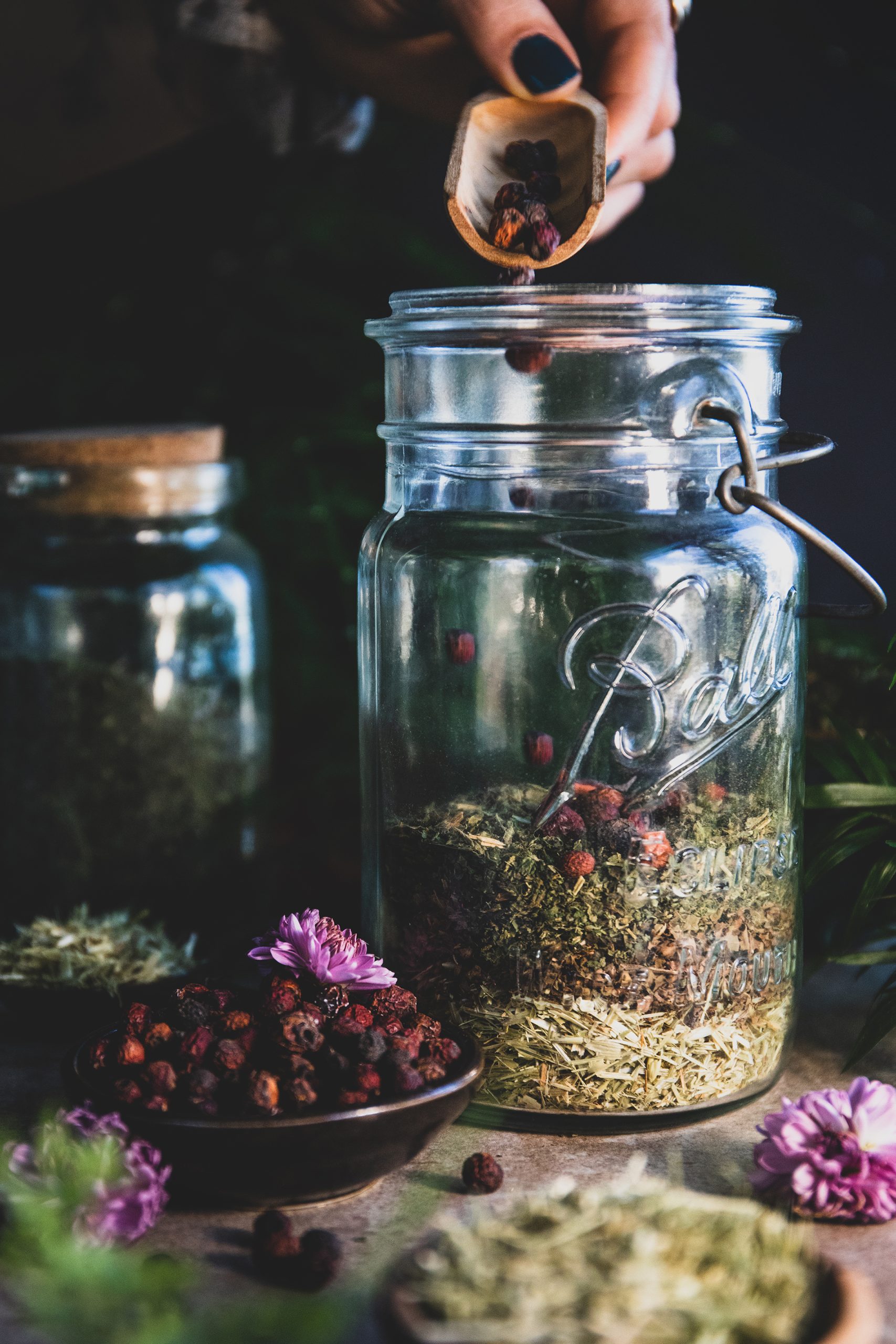 Hawthorn berried being added to a dried herbal blend