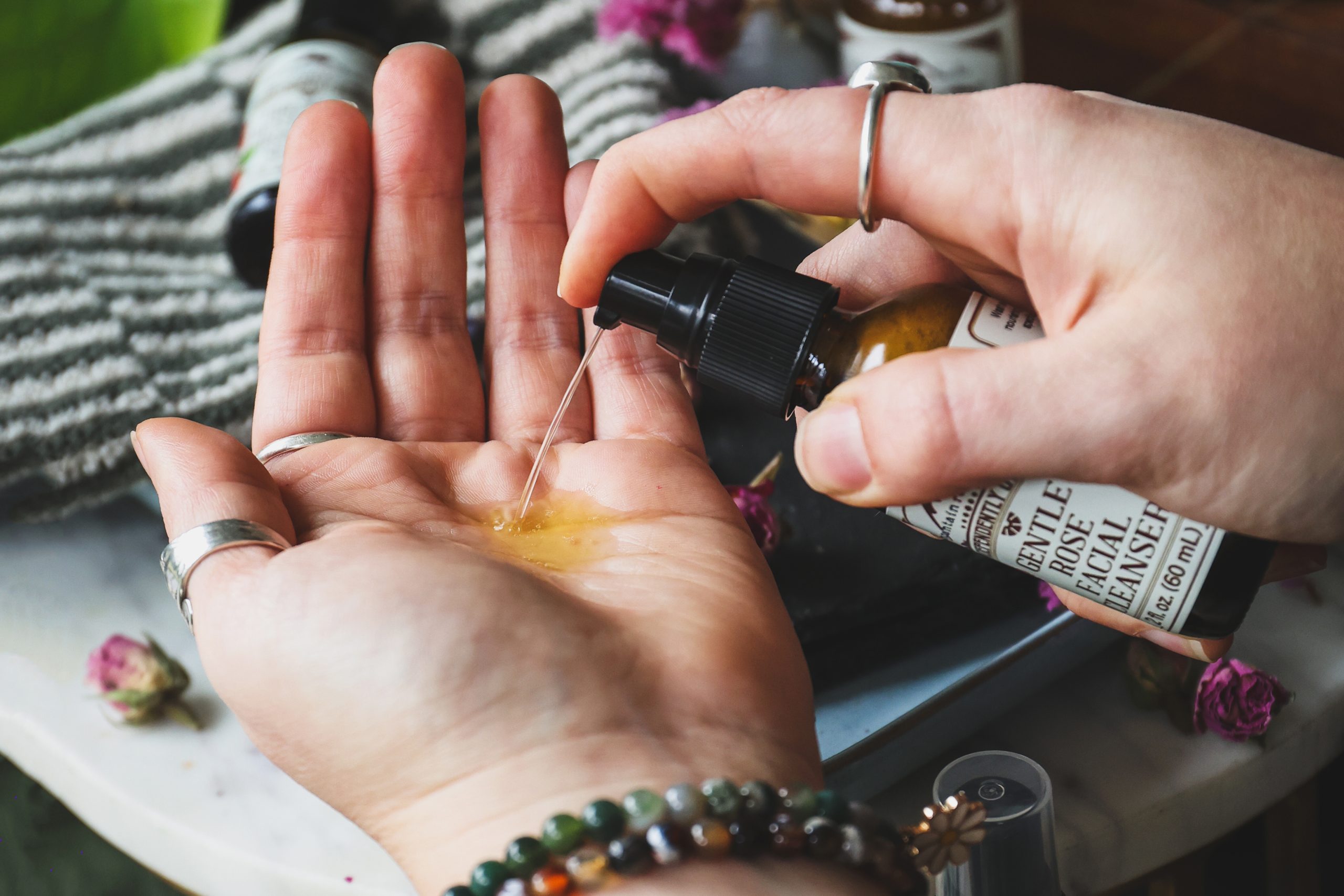 Gentle Rose Cleanser being dispensed into a palm for washing