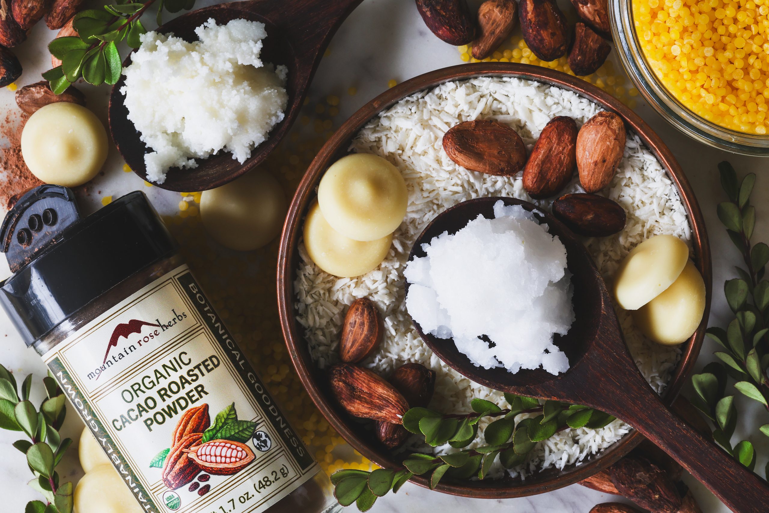 Ingredients for chocolate macaroon lip balm sit out on a counter