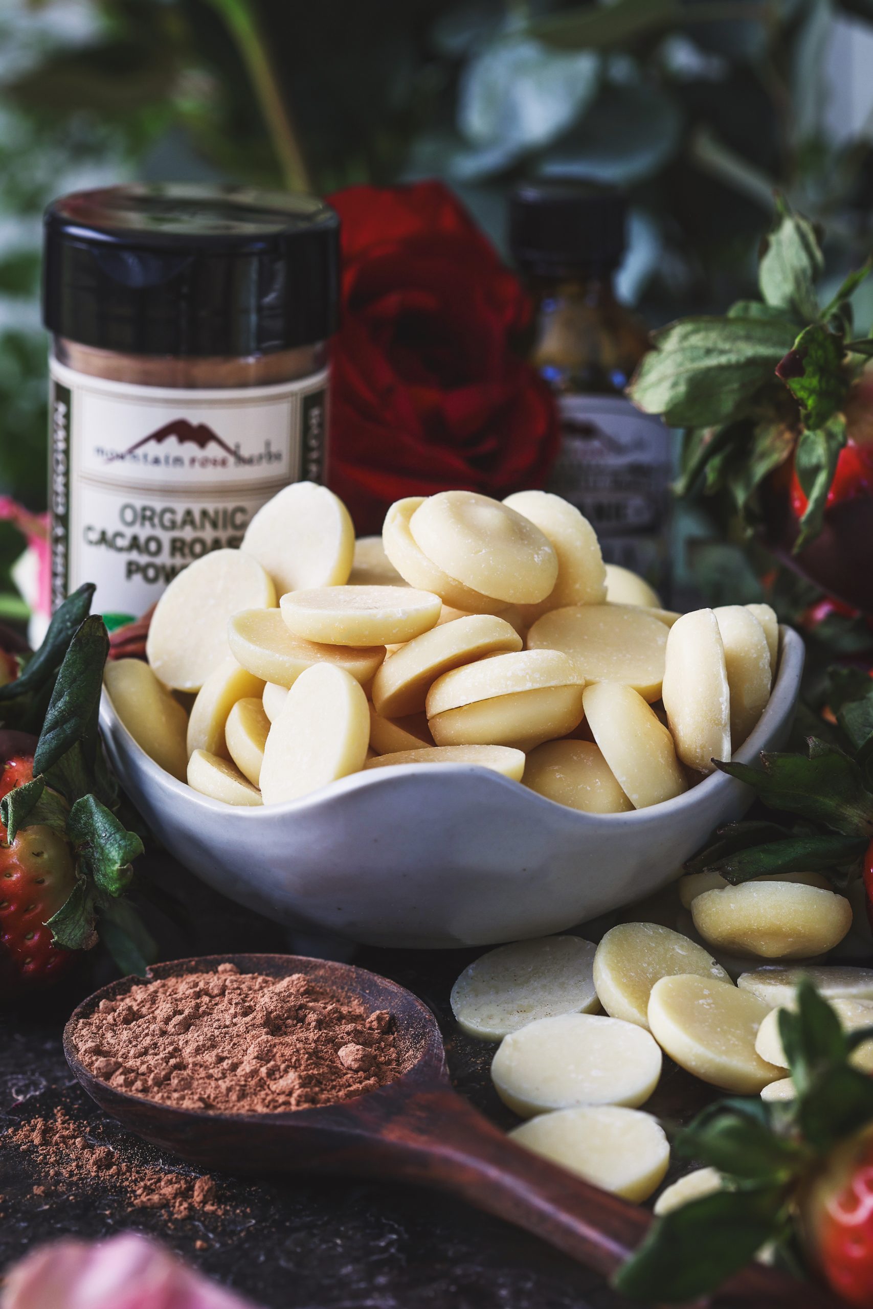 A close up photo of roasted cacao wafers with other ingredients around them