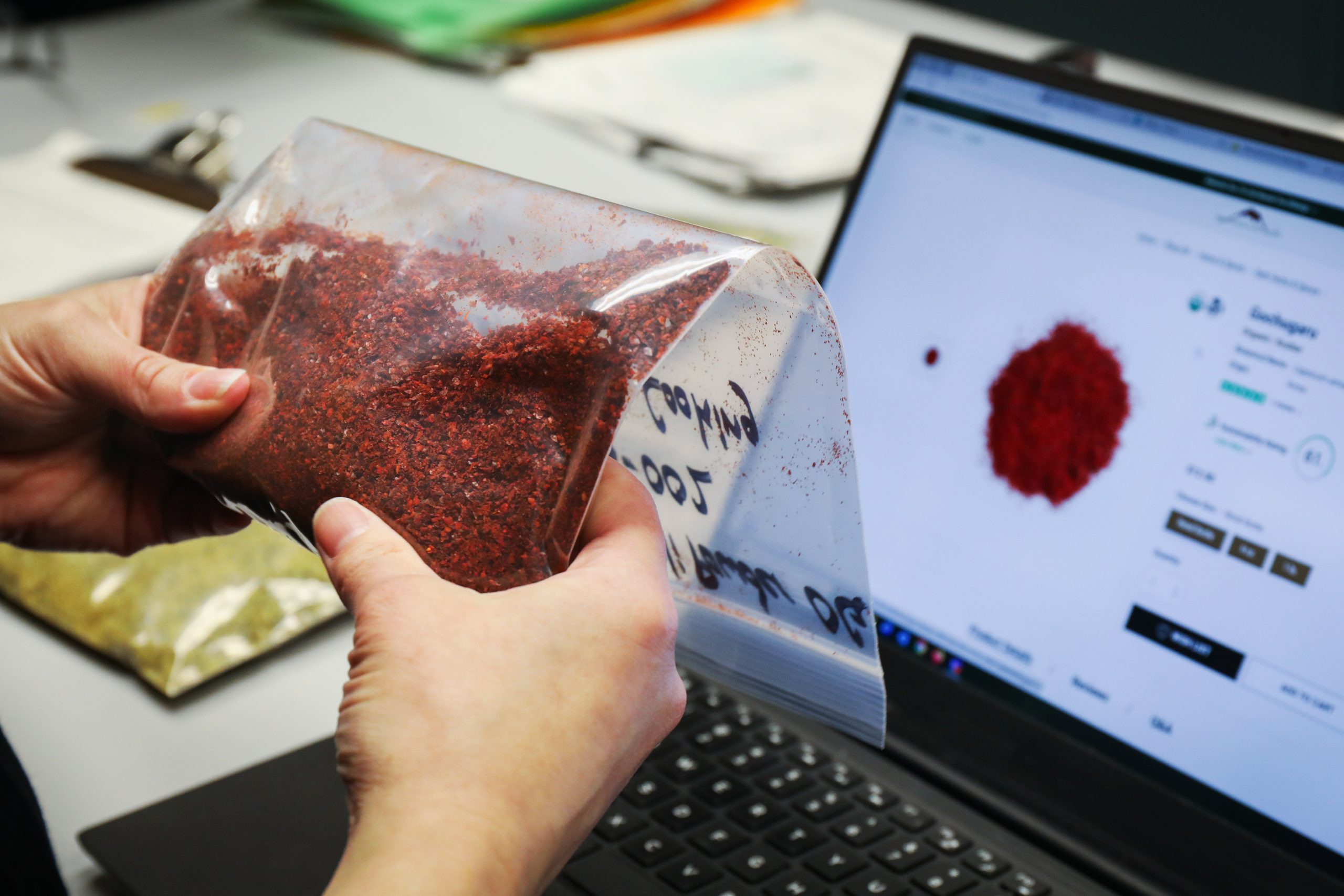 A bag of herbs being studied by Mountain Rose Herbs employee