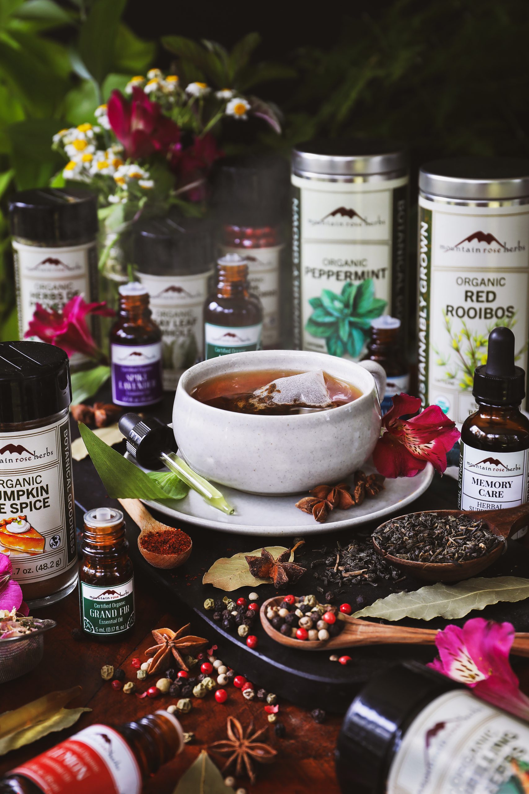 Mountain Rose Herbs products around a steaming mug of tea