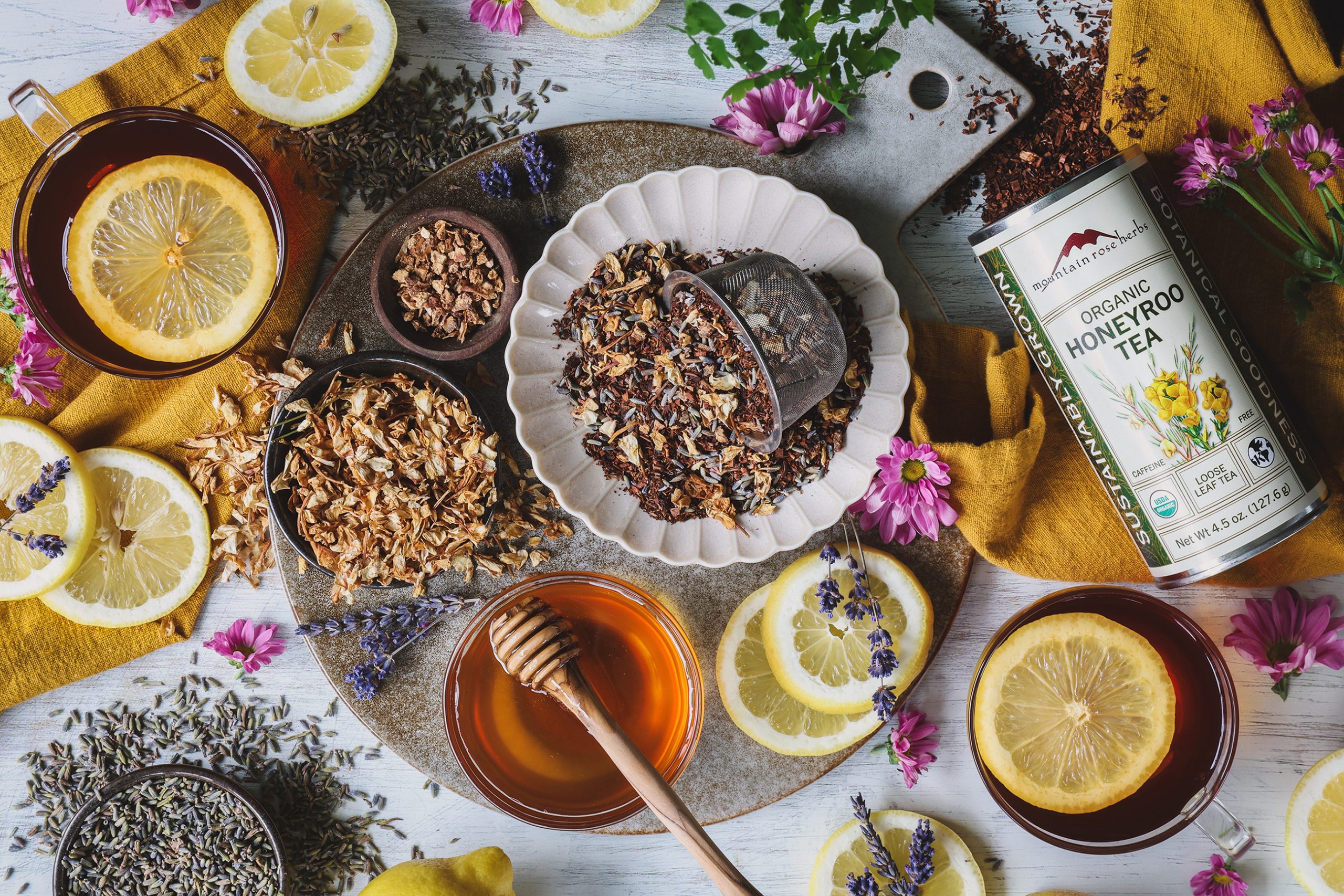 An overhead photo of a tea setting including jasmine lavender tea blend, honey, and lemon