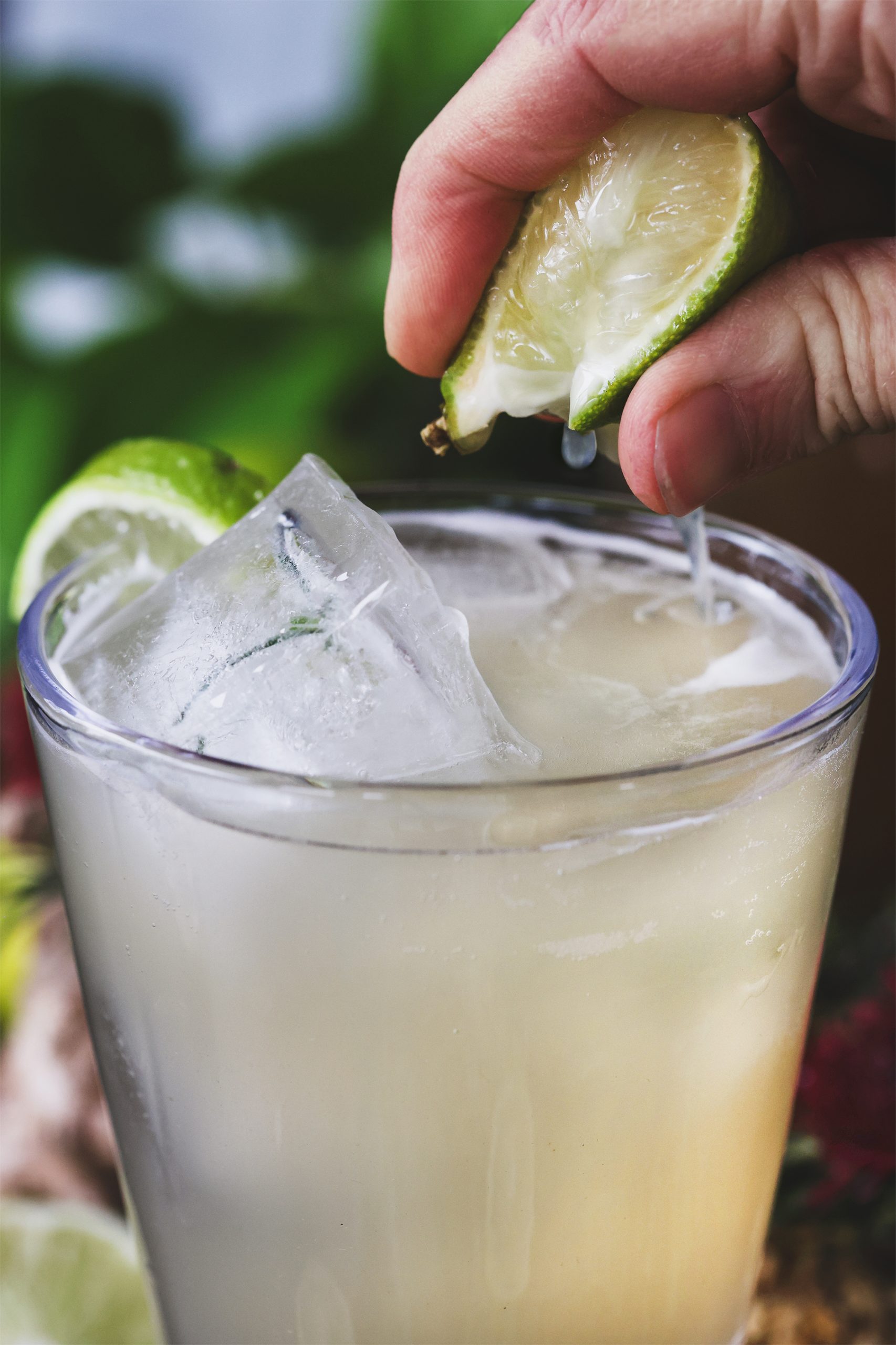 A close up photo of fresh lime being squirted into mule mocktail