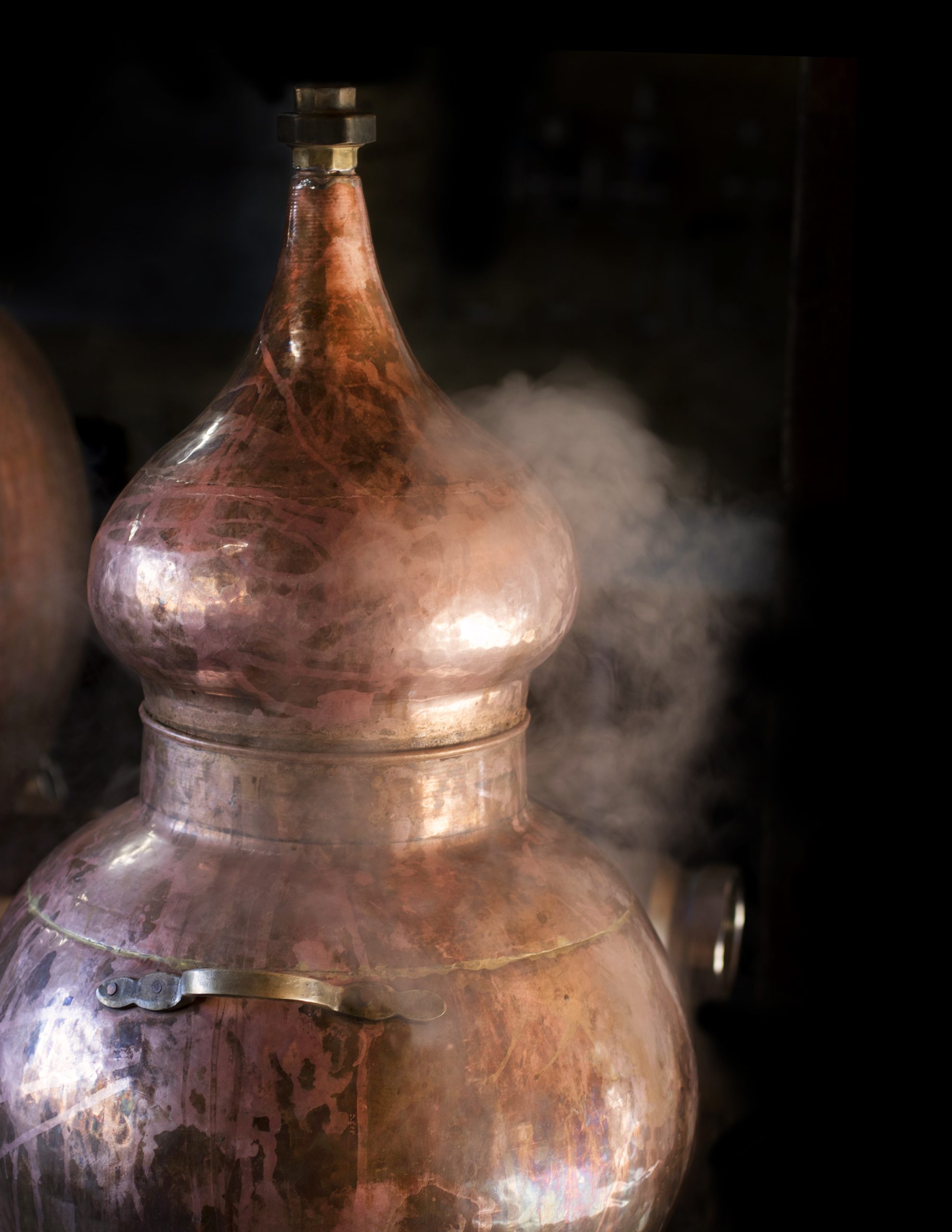 A copper still steams